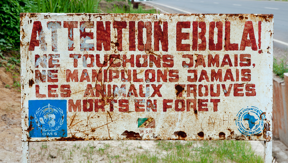 Picture of sign saying "Attention Ebola! Ne Touchons Jamais Ne Manipulons Jamais"